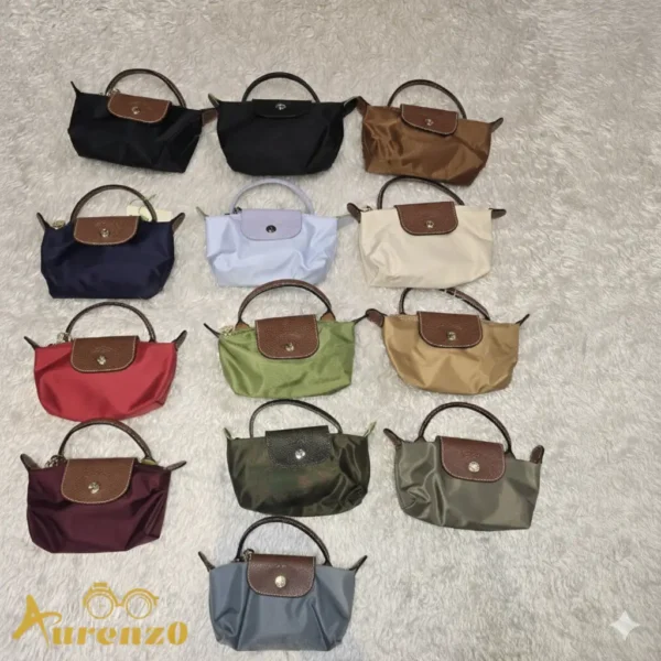 Longchamp Mini Pouch Bag (Le Pliage style), Blue Nylon Canvas body with Brown leather flap and top handle, gold-tone snap closure, and detachable crossbody strap.