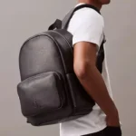 Calvin Klein Backpack: Black 100% genuine leather CK Campus backpack with minimalist design and 37.5 x 19 cm dimensions.