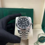 "5 Breathtaking views of the iconic Rolex Sky-Dweller Watch in silver stainless steel, featuring the incredible black dial and 42mm mirror original design."
