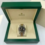 Rolex GMT-Master II Watch in two-tone gold and silver steel, showcasing the incredible black dial and 40mm mirror original design."