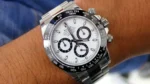 "7 Incredible angles of the legendary Rolex Daytona Watch with white dial and silver stainless steel strap, highlighting its Japanese automatic movement and Swiss design."